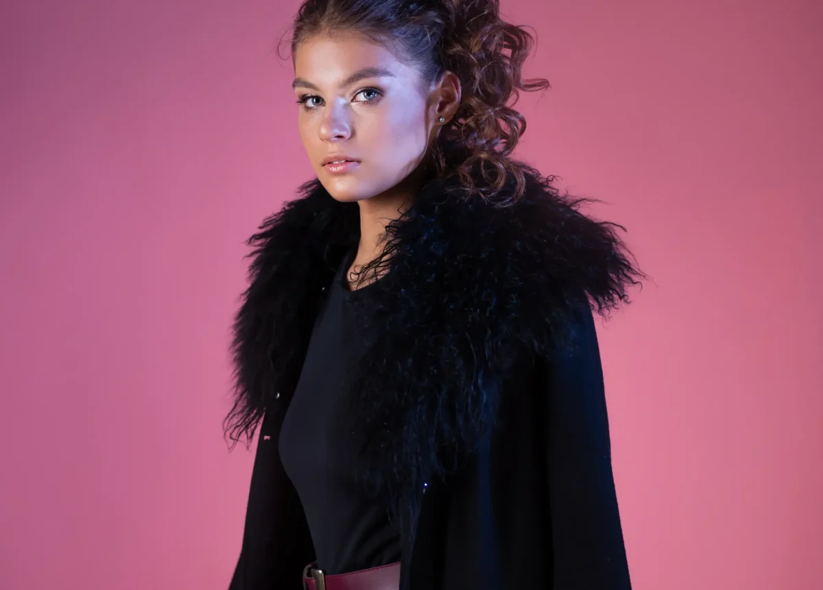 beautiful-young-brunette-stylish-image-coat-with-fur-collar-black-bodysuit-portrait-pink-background